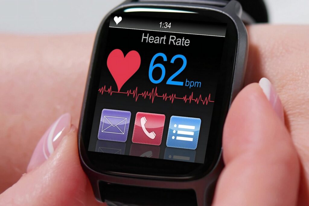 Smartwatch displaying heart rate and ECG graph with a reading of 62 bpm